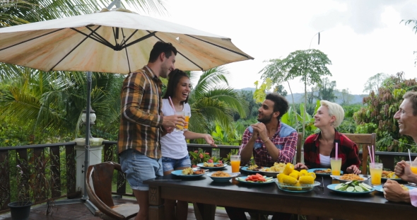 Couple Telling Toast Standing Up People Eating On Terrace Young Friends Sitting At Table Outdoors alt