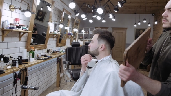 VideoHive The Barber Holds Up a Mirror and Shows Real Client Back in the Barbershop 19922819 VideoHive The Barber Holds Up a Mirror and Shows Real Client Back in the Barbershop 19922819
