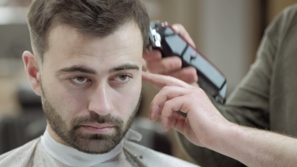 VideoHive Master Cuts Hair and Beard of Men in the Barbershop Hairdresser Makes Hairstyle for a Young Man 19922932 VideoHive Master Cuts Hair and Beard of Men in the Barbershop Hairdresser Makes Hairstyle for a Young Man 19922932