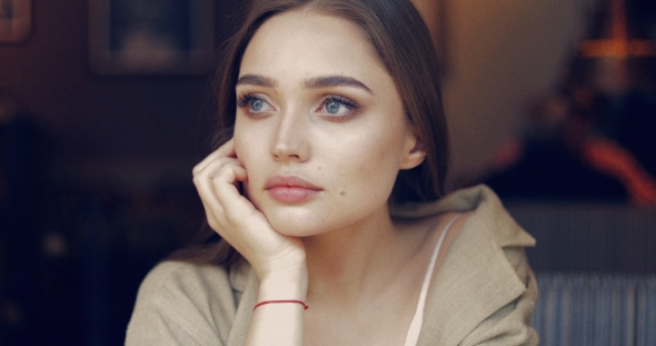 Lovely Female Sitting and Looking Away alt