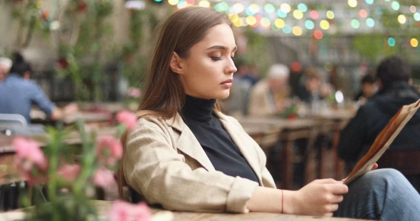 Woman Looking Through Menu alt