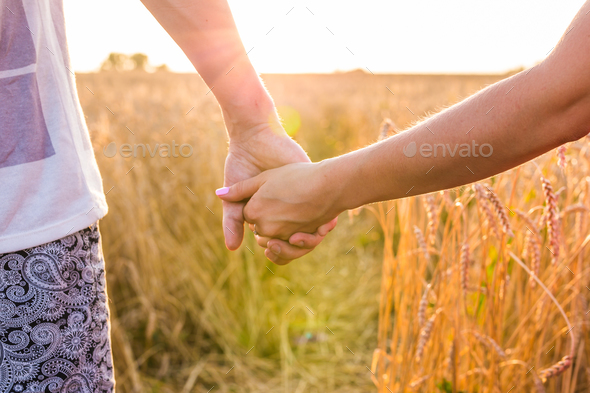 holding hands sunrise