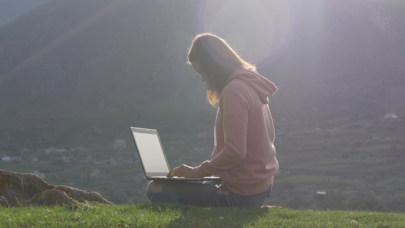 Woman with Laptop in the Sunlight