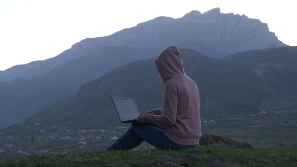 Woman with a Laptop Against of Mountains