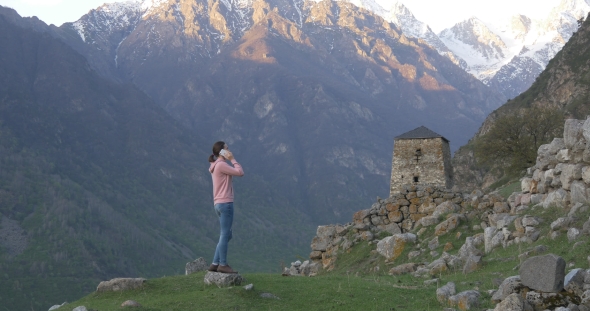 Woman on the Background of Ruins and Tower
