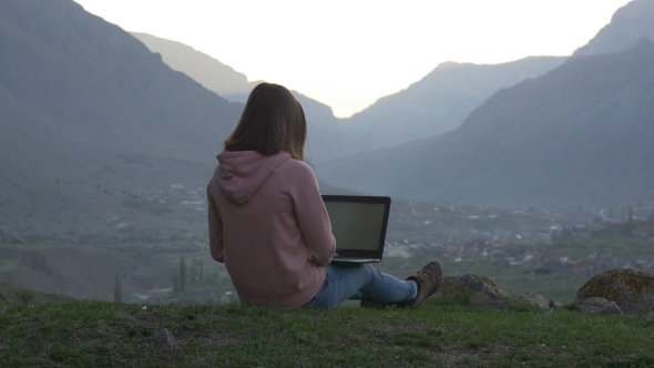 Woman with Laptop in the Rocky Mountains