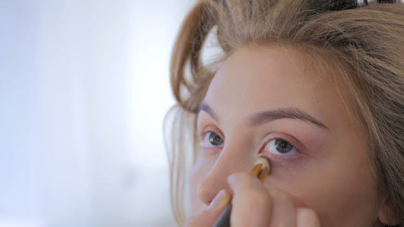 Professional Make-up Artist Applying Cream Base Eyeshadow Primer To Model Eye