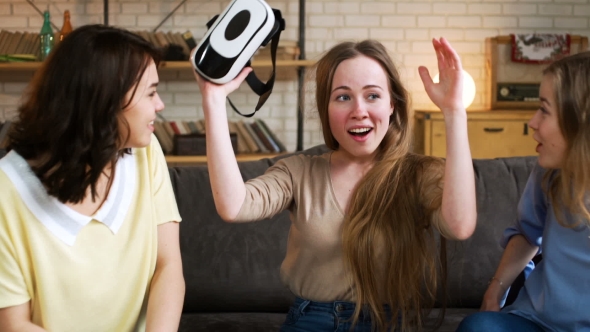 Three Young Energetic Girlfriends Laugh and Move Funny Using Together VR Device