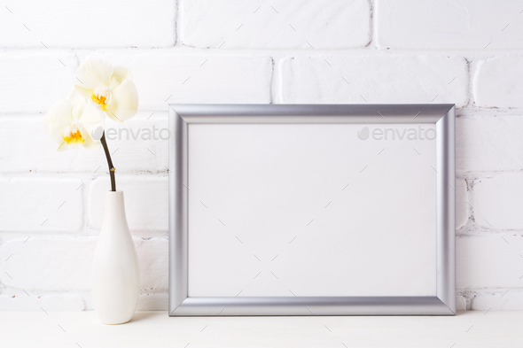 Silver landscape frame mockup with soft yellow orchid in vase - Stock Photo - Images