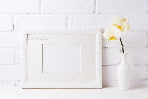 White frame mockup with soft yellow orchid in vase - Stock Photo - Images