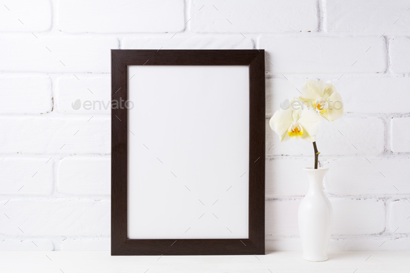 Black brown frame mockup with soft yellow orchid in vase - Stock Photo - Images