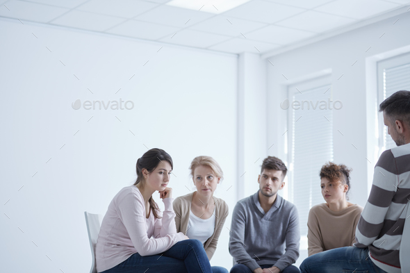 Sad girl in a group - Stock Photo - Images