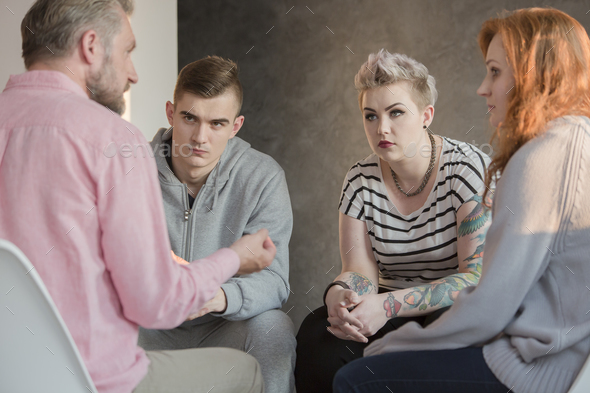 Psychologist talking with teenagers - Stock Photo - Images