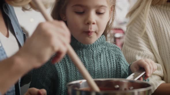 Close up video of little cute girl cooking in the kitchen. Shot with RED helium camera in 8K. alt