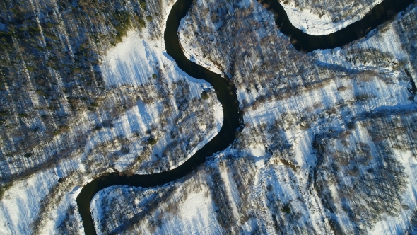 Meandering River Flows Through Plain Among Woodland