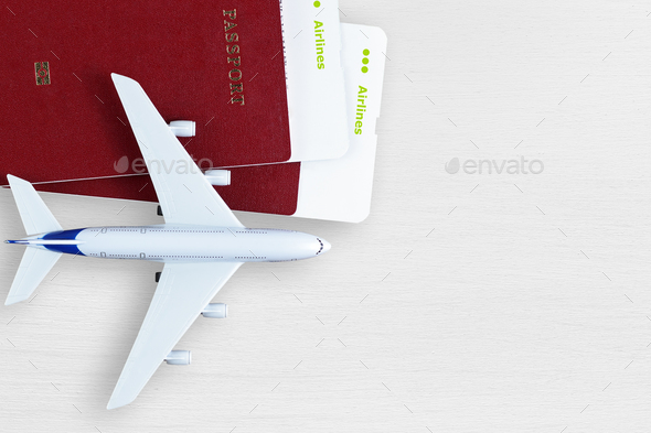 Boarding passes, passports and toy plane on table - Stock Photo - Images
