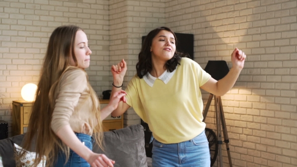 Three Young Active Girlfriends Dance Disco and Hop Together, While Having Fun at Home