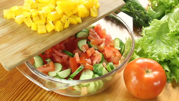 Chopped Yellow Bell Pepper Falling Into Bowl.