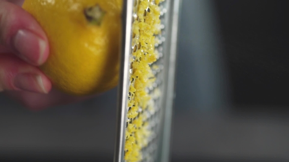 The Cook Grates Lemon Zest on the Grater, Citrus and Fruits, Vitamins in Food, Healthy Diet alt