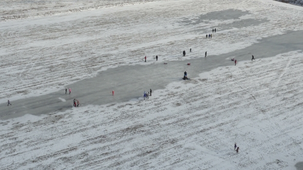 Aerial View, People Walk and Ice Skating on Outdoor Ice