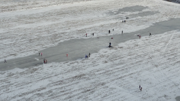 Aerial View, People Walk and Ice Skating on Outdoor Ice, Stock Footage