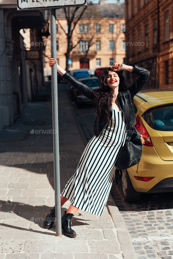 Beautiful fashionable lady posing on old street Stock Photo by simbiothy