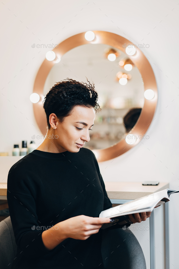 Attractive woman at the mirror in beauty studio - Stock Photo - Images