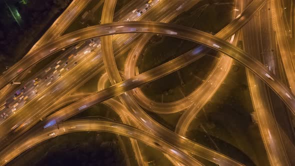 Road Intersection and Cars Traffic at Night. Flyover. Aerial Top Down View alt