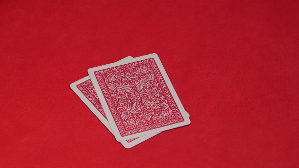 Human Hand Opening Two Cards in Poker Game.