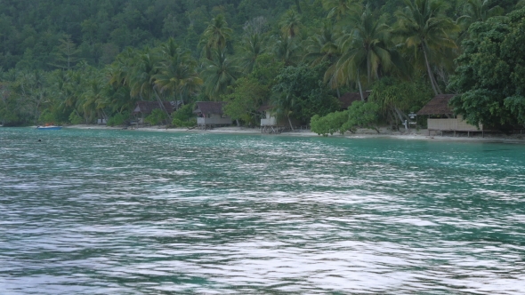 Tropical Rain Over the Bamboo Homestay Huts on the Beach, Gam Island, Raja Ampat, West Papua alt