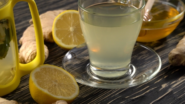 Ginger Tea with Lemon, Mint and Honey on Wooden Background.