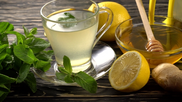 Ginger Tea with Lemon, Mint and Honey on Wooden Background.