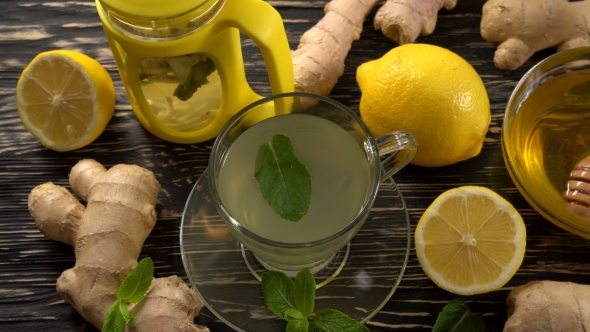 Ginger Tea with Lemon, Mint and Honey on Wooden Background.