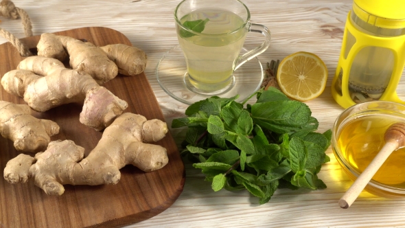 Ginger Tea with Lemon, Mint and Honey on Wooden Background.