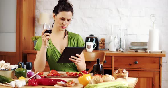 Beautiful Woman Checks the Recipe for Spring Food on the Tablet