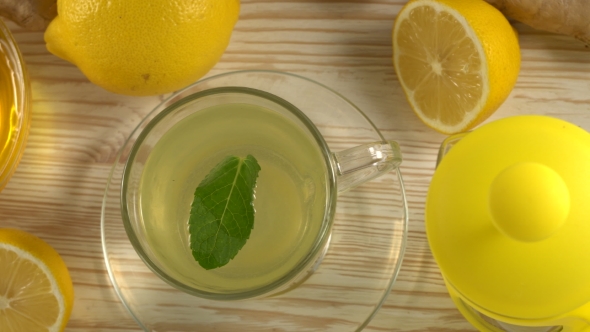 Ginger Tea with Lemon, Mint and Honey on Wooden Background.