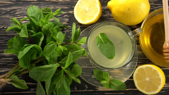 Ginger Tea with Lemon, Mint and Honey on Wooden Background.