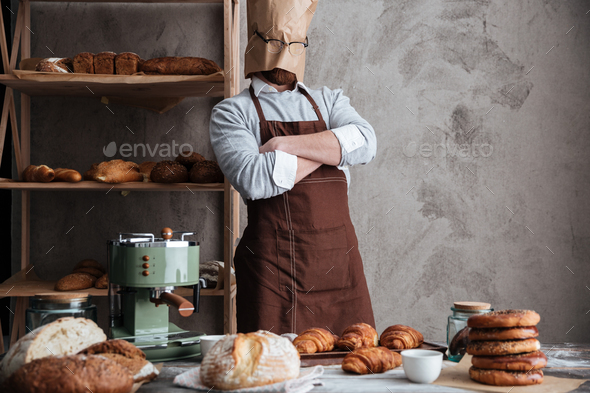 ?an baker standing at bakery near bread