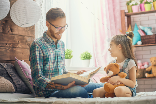 daddy reading a book - Stock Photo - Images