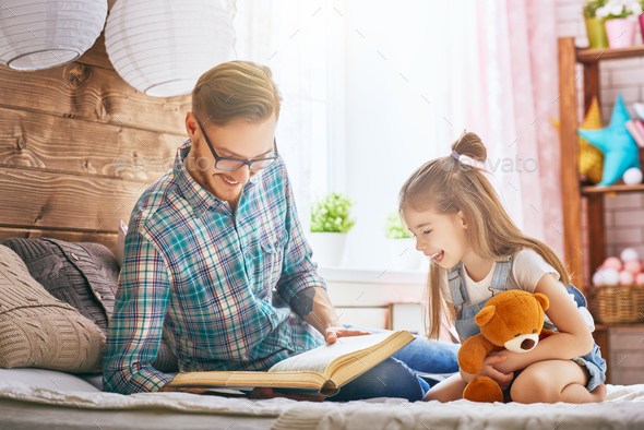 daddy reading a book - Stock Photo - Images