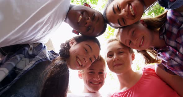 Schoolkids forming huddle in school premises 4k alt
