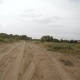 Car Driving Along a Rural Dirt Road - VideoHive Item for Sale