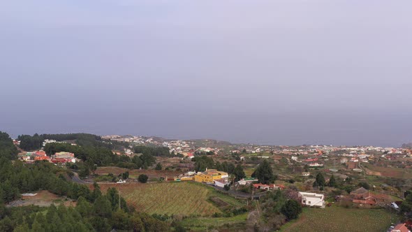 Coastal town on the Atlantic shores of Canary Islands,Spain,fog over the sea. alt