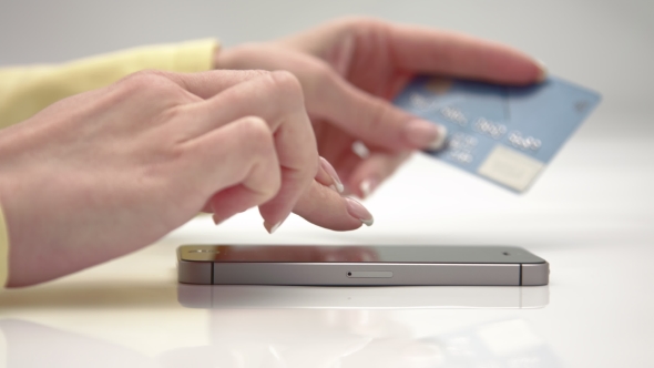 The Girl Makes Payments By Using Phone alt
