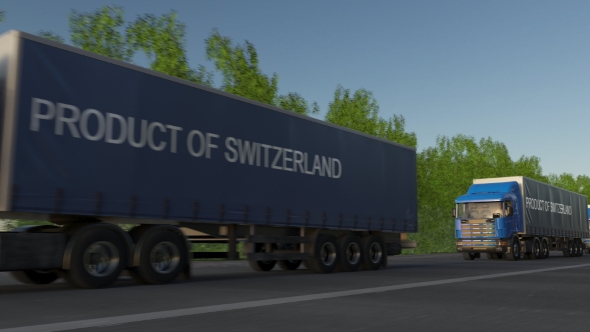 Moving Freight Semi Trucks with PRODUCT OF SWITZERLAND Caption on the Trailer alt