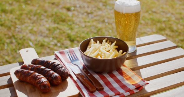 Three Tasty Smoked Grilled Sausages with Chips alt