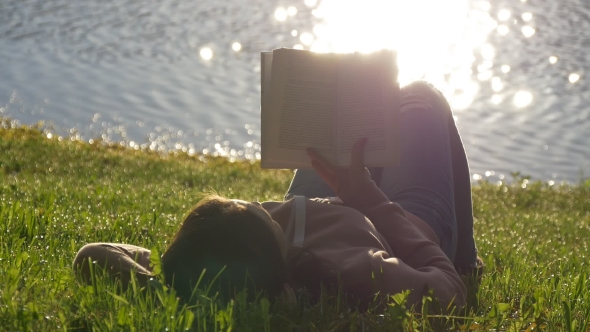 Reading a Book on a Lawn in the Park