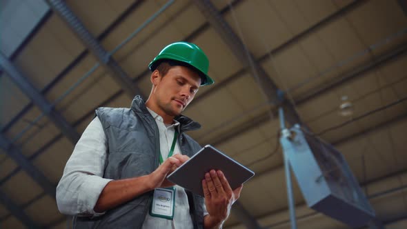 Supervisor Manager Holding Tablet Computer in Modern Agricultural Facility Alone alt