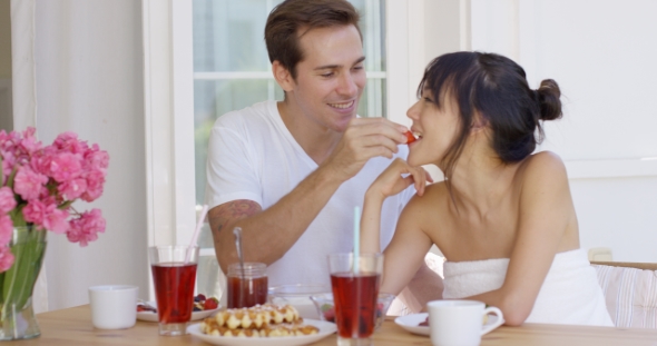 Man Feeding His Wife Fruit at Breakfast, Stock Footage | VideoHive