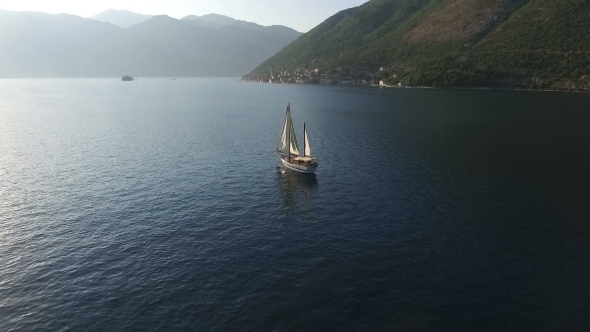 Aero Video of the Yacht Near the Mountains in the Bay of Kotor